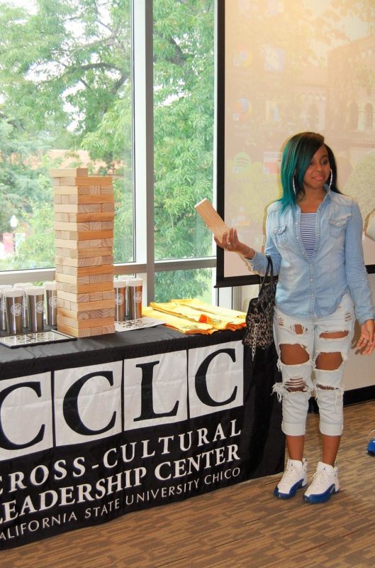 A girl standing next to CCLC table